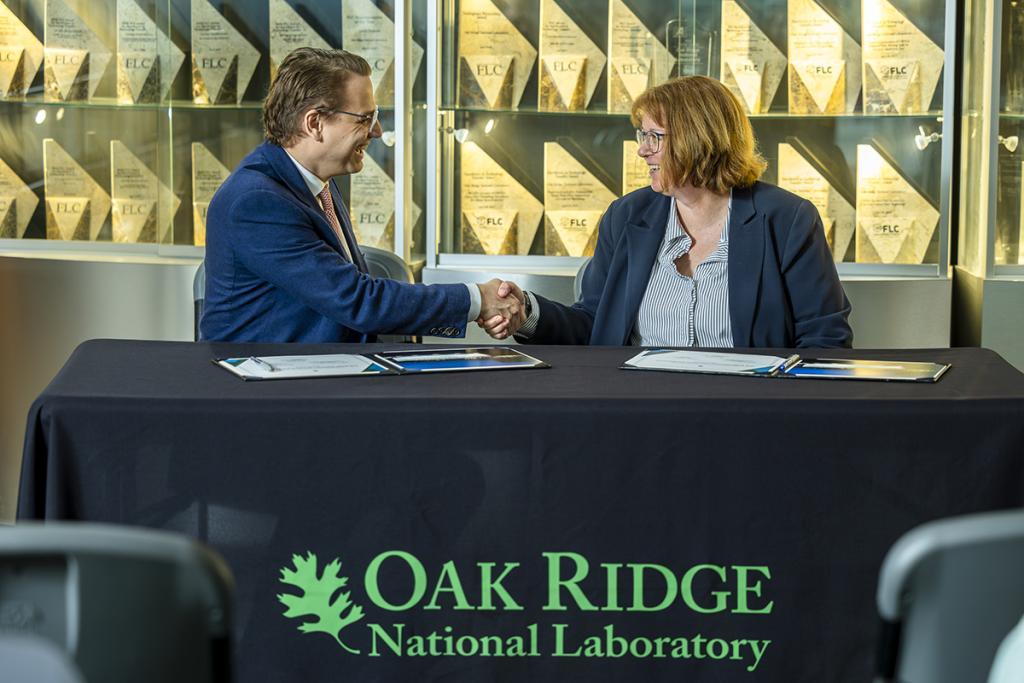 image of two people shaking hands:Hood Whitson, chief executive officer of Element3, and Cynthia Jenks, associate laboratory director for the Physical Sciences Directorate, shake hands during the Element3 licensing event at ORNL on May 3, 2024. Credit: Carlos Jones/ORNL, U.S. Dept. of Energy